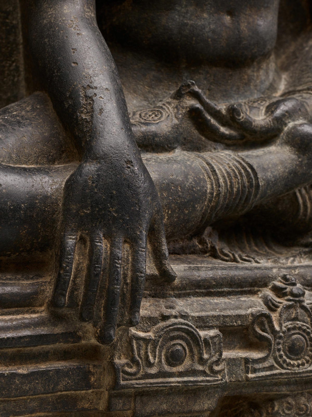 Detailed view of the Buddha's right hand touching the ground.